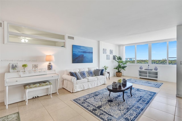 living room with light tile patterned flooring and ceiling fan