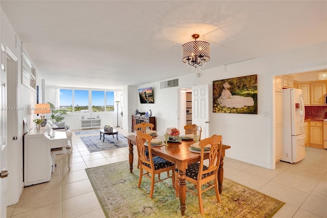 tiled dining area with a chandelier