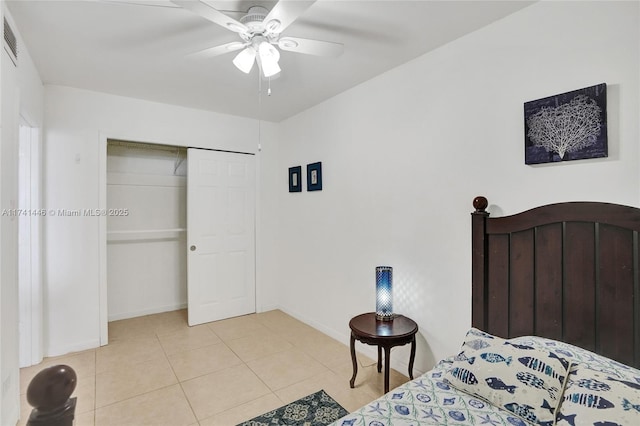 tiled bedroom with ceiling fan and a closet