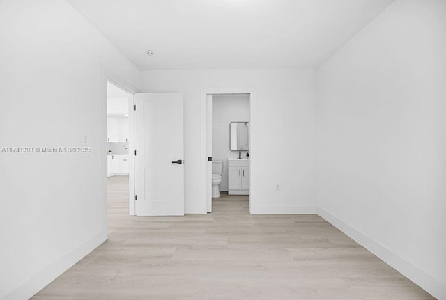 interior space featuring ensuite bathroom and light hardwood / wood-style floors