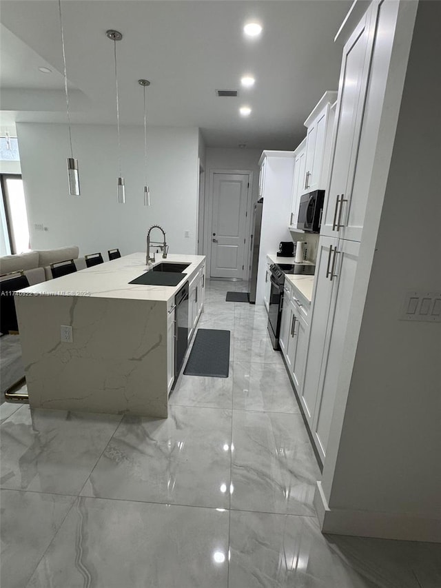 kitchen with sink, decorative light fixtures, black appliances, a center island with sink, and white cabinets