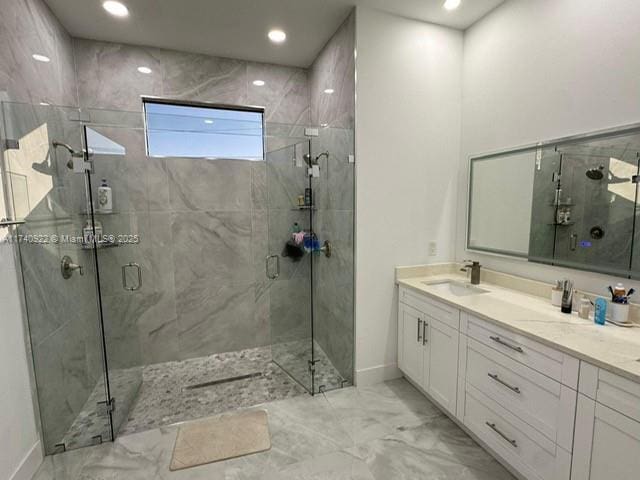 bathroom featuring vanity and an enclosed shower