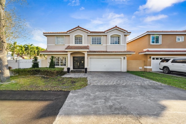 mediterranean / spanish-style house with a garage and a front yard