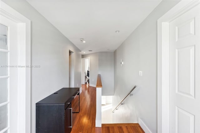 hallway with hardwood / wood-style flooring