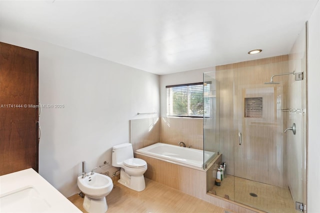 full bathroom with a bidet, sink, tile patterned flooring, independent shower and bath, and toilet