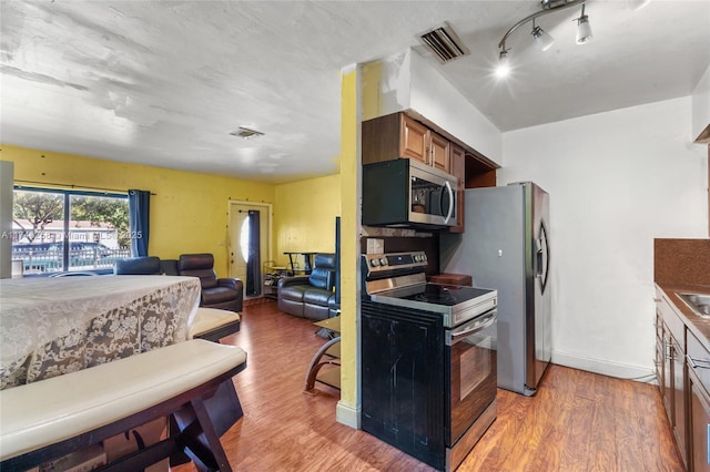 kitchen with appliances with stainless steel finishes and light wood-type flooring