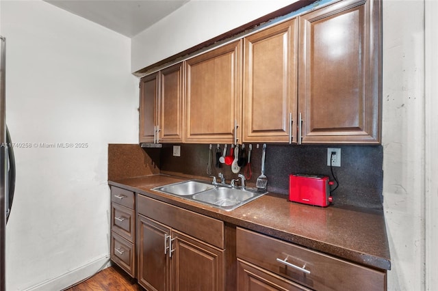 kitchen featuring sink, hardwood / wood-style floors, and decorative backsplash