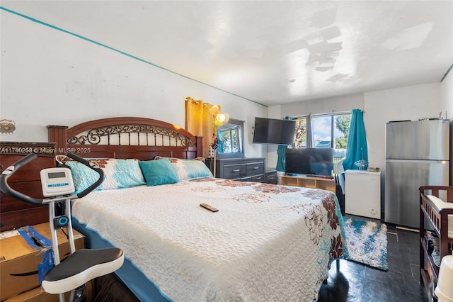 bedroom featuring stainless steel refrigerator