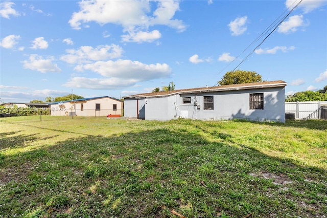 rear view of house with a yard