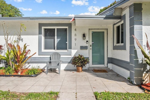 entrance to property with a patio