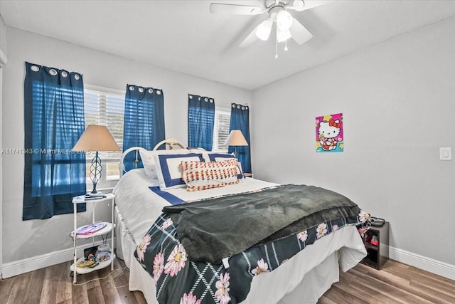 bedroom with hardwood / wood-style floors and ceiling fan