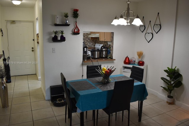 tiled dining area featuring an inviting chandelier