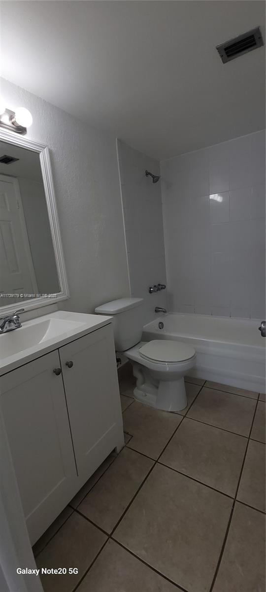 10900 SW 104th St Unit 316, Miami, FL 33176 - full bath with tile patterned floors, vanity,  shower combination, toilet, and visible vents