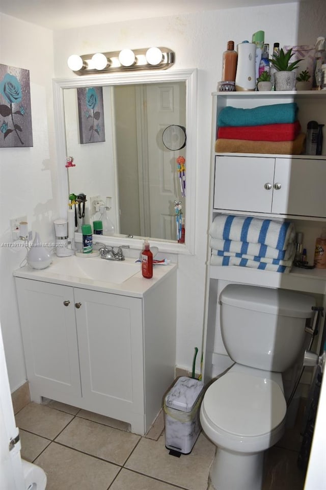 bathroom featuring vanity, tile patterned floors, and toilet