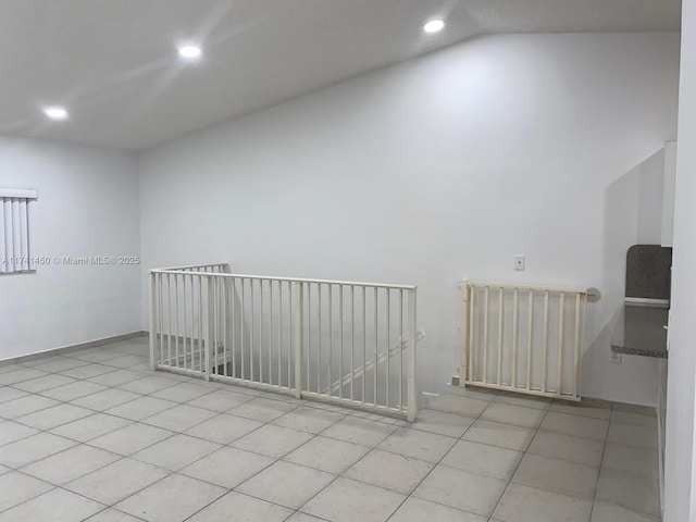 tiled empty room featuring radiator heating unit