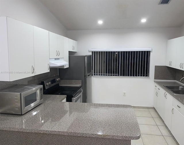 kitchen with light tile patterned floors, appliances with stainless steel finishes, sink, and white cabinets