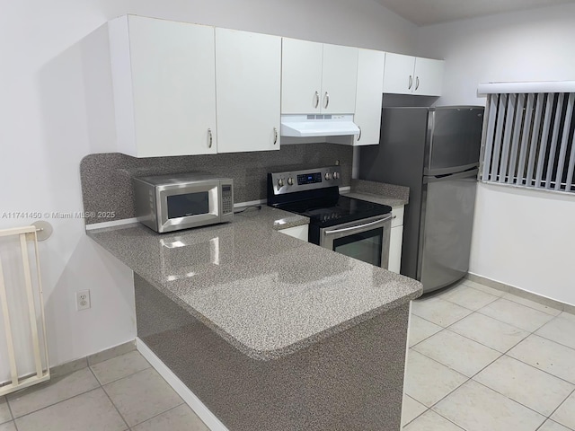 kitchen featuring light tile patterned flooring, appliances with stainless steel finishes, and white cabinets