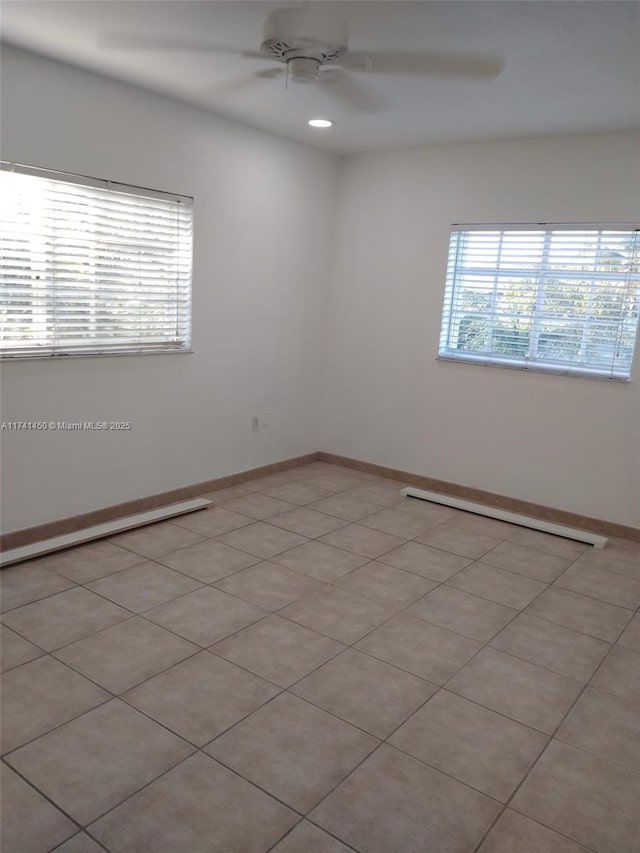 empty room featuring light tile patterned floors and ceiling fan