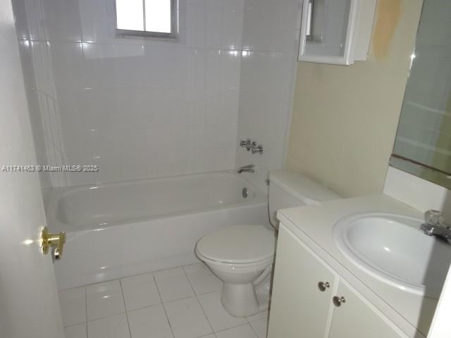 full bathroom featuring vanity, tile patterned flooring, tiled shower / bath combo, and toilet