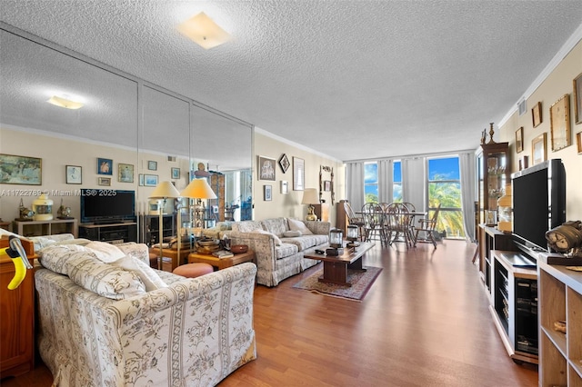 800 Parkview Dr Unit 523, Hallandale Beach, FL 33009 - living room featuring crown molding, expansive windows, a textured ceiling, and hardwood / wood-style flooring