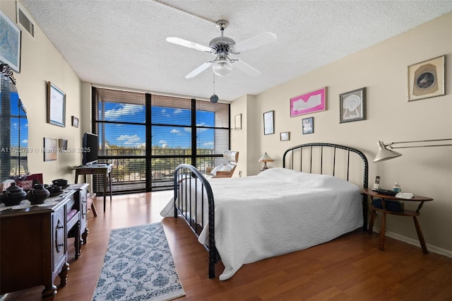 800 Parkview Dr Unit 523, Hallandale Beach, FL 33009 - bedroom with ceiling fan, dark hardwood / wood-style floors, floor to ceiling windows, and a textured ceiling