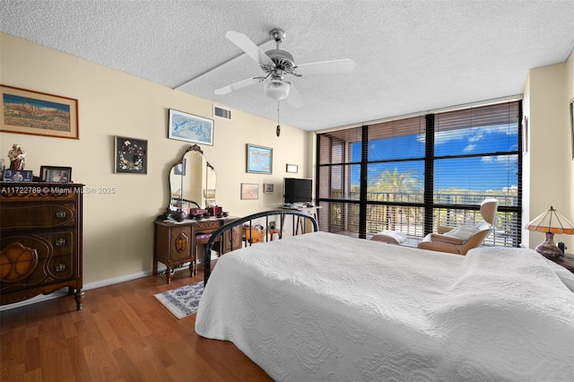 800 Parkview Dr Unit 523, Hallandale Beach, FL 33009 - bedroom featuring ceiling fan, hardwood / wood-style floors, a textured ceiling, and a wall of windows