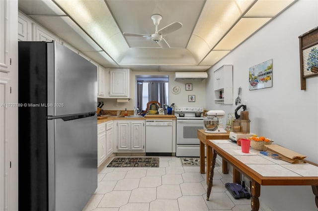 800 Parkview Dr Unit 523, Hallandale Beach, FL 33009 - kitchen featuring white appliances, a tray ceiling, a wall unit AC, ceiling fan, and white cabinets