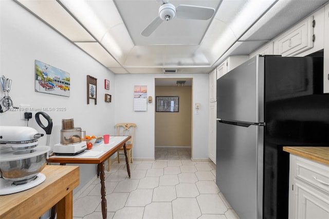 800 Parkview Dr Unit 523, Hallandale Beach, FL 33009 - kitchen with stainless steel refrigerator, white cabinetry, light tile patterned floors, ceiling fan, and a raised ceiling