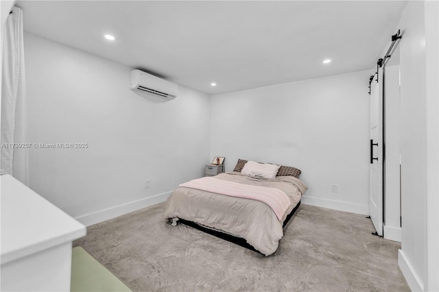 bedroom with a barn door and a wall mounted air conditioner