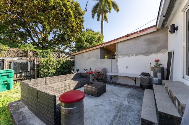 view of patio with an outdoor living space and electric water heater