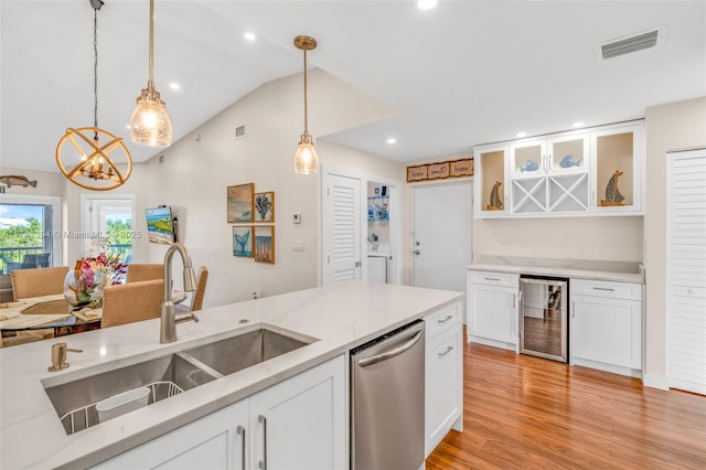 kitchen featuring sink, dishwasher, white cabinets, decorative light fixtures, and beverage cooler