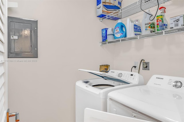 clothes washing area with independent washer and dryer and electric panel