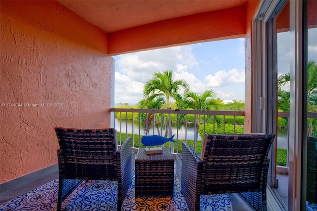 balcony featuring a water view