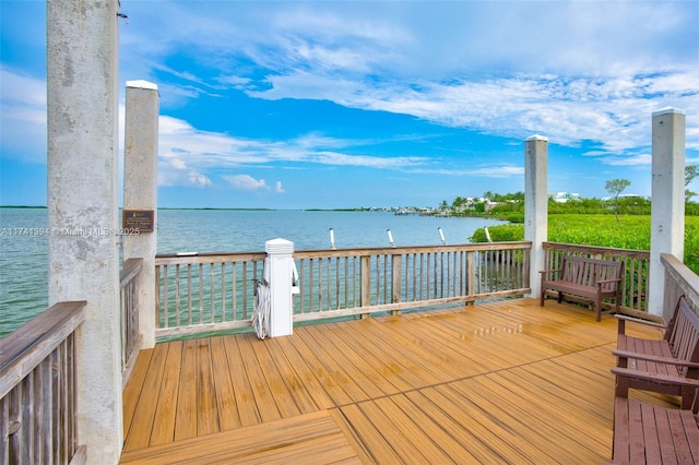 wooden terrace featuring a water view