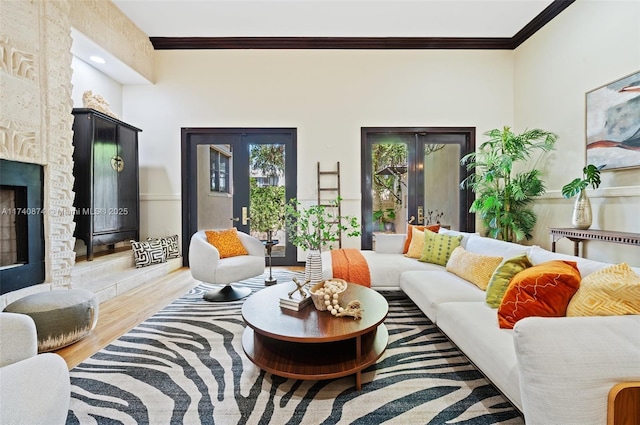 living room featuring crown molding, a fireplace, and hardwood / wood-style floors