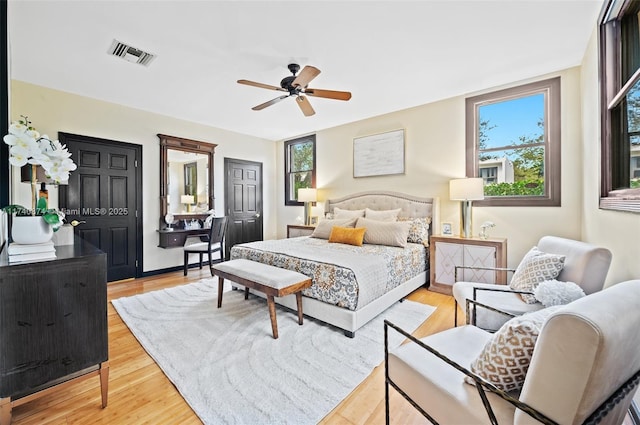 bedroom with ceiling fan and light wood-type flooring