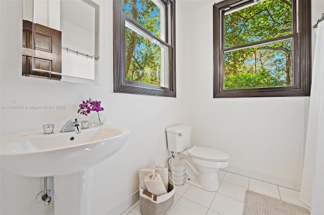 bathroom featuring toilet and tile patterned flooring