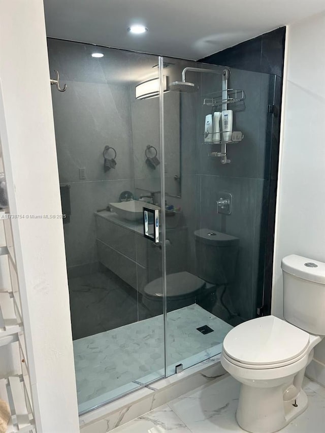 bathroom featuring an enclosed shower and toilet