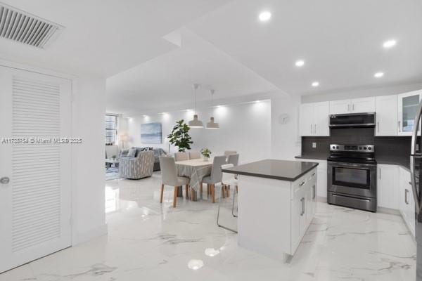 kitchen featuring stainless steel range with electric stovetop, decorative light fixtures, a center island, range hood, and white cabinets