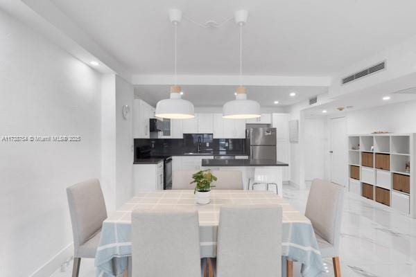 dining space featuring sink