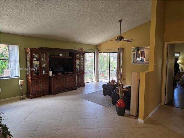 living room with light tile patterned floors, a textured ceiling, lofted ceiling, and a ceiling fan