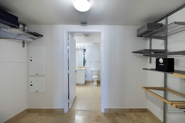 walk in closet featuring sink