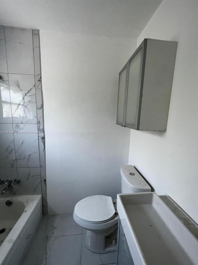 bathroom featuring a bath and toilet