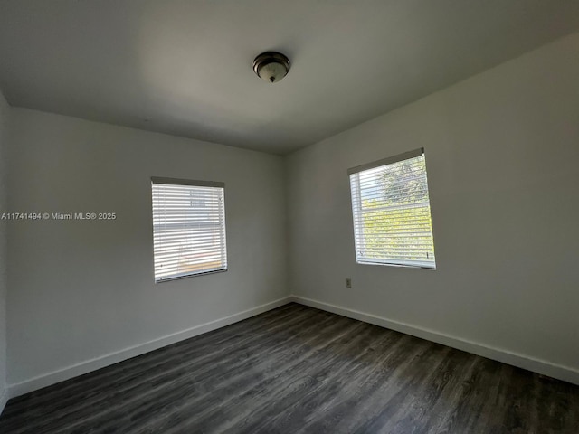 spare room featuring dark wood-type flooring