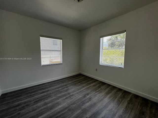 spare room with dark hardwood / wood-style floors