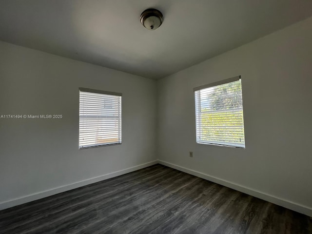 spare room featuring dark wood-type flooring