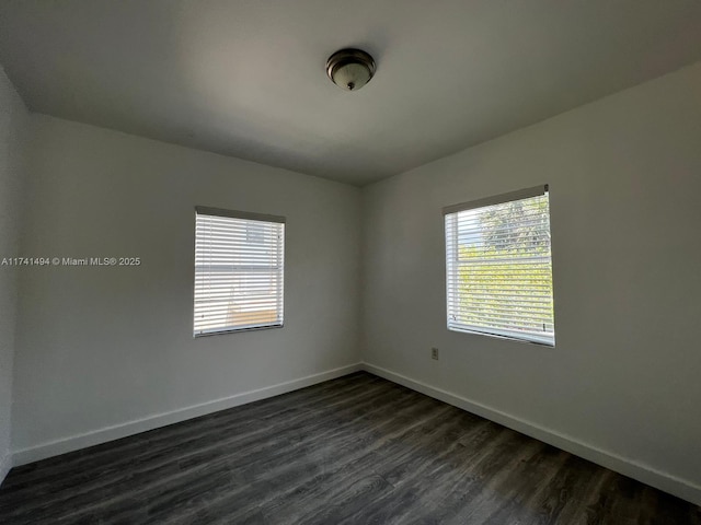 unfurnished room with dark hardwood / wood-style floors