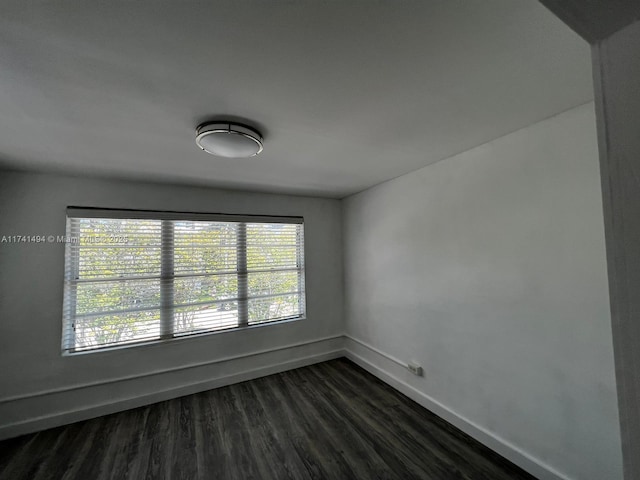 unfurnished room featuring dark hardwood / wood-style flooring