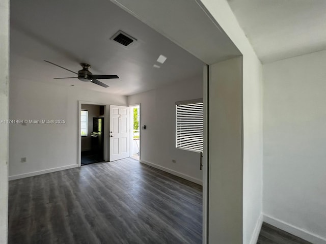 empty room featuring ceiling fan and dark hardwood / wood-style flooring