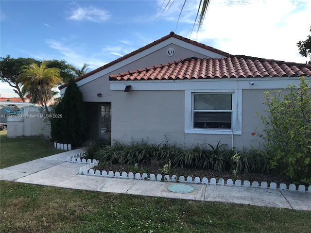 view of side of home with a lawn